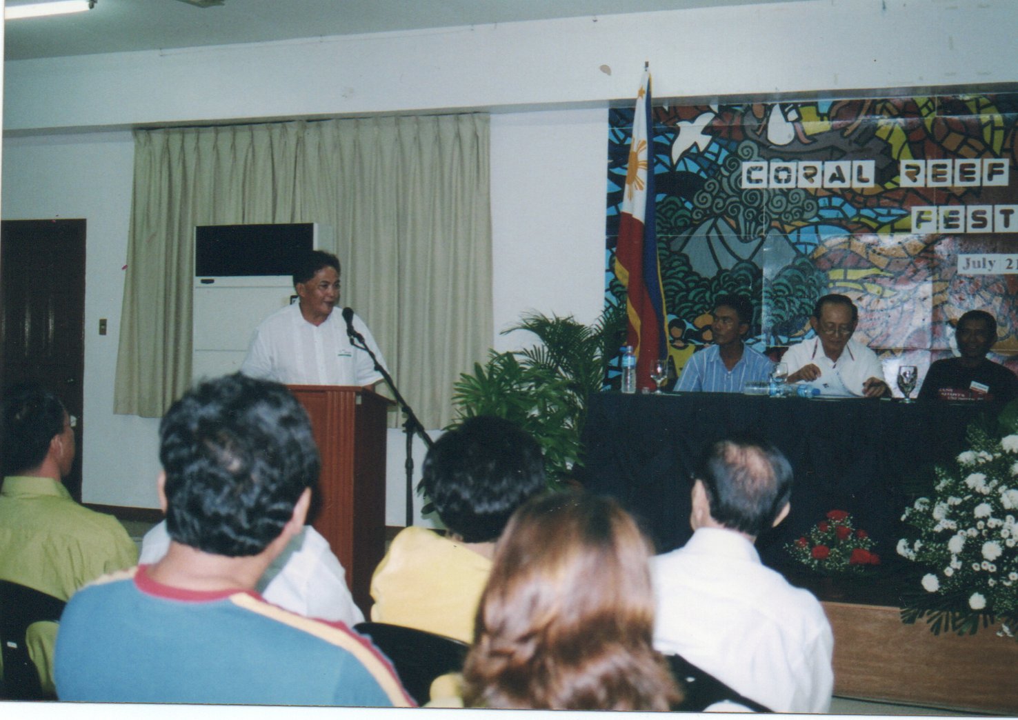 Man talking in front of an audience