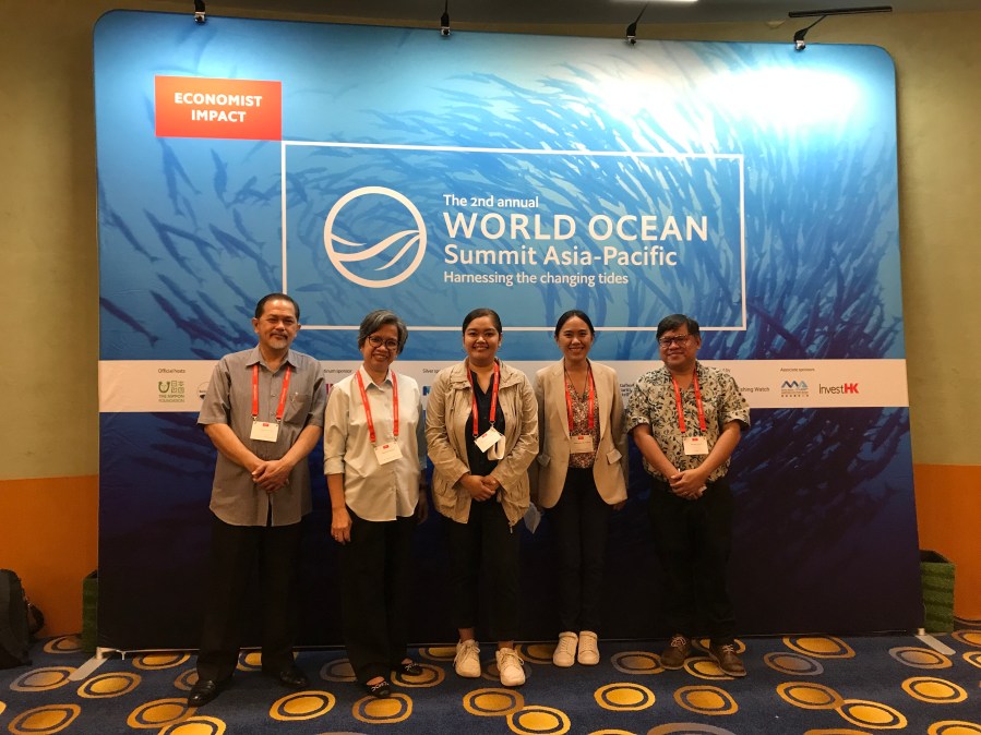 5 people in front of a blue background